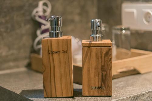 two wooden bottles sitting on top of a counter at Sweet Orange Pondok in Ubud