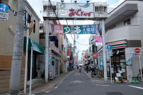 an empty street in an asian city with signs at The Light Inn Tokyo in Tokyo