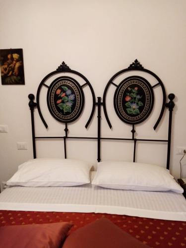 a bed with two pillows in a room at Podere Battegone in Menestrello