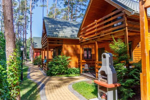 a log cabin with a walkway outside of it at Pinia in Pobierowo