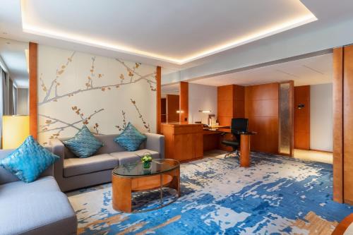 a living room with a couch and a table at China Hotel Guangzhou - Subway direct to Pazhou Exhibition Center, Free shuttle during Canton Fair & Exhibitor registration Counter in Guangzhou