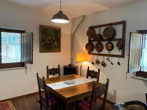 a dining room with a table and some pots and pans at Podere Battegone in Menestrello