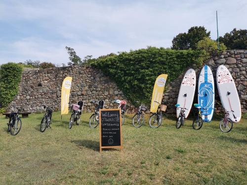 a group of bikes and surfboards parked next to a wall at Willa Moryń in Moryń