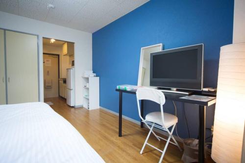 Ένα ή περισσότερα κρεβάτια σε δωμάτιο στο エバグリーンヴィラ太秦206もみじ