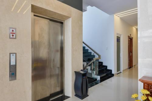 a hallway with a staircase in a house at Paradise Cu Chi Hotel in Củ Chi
