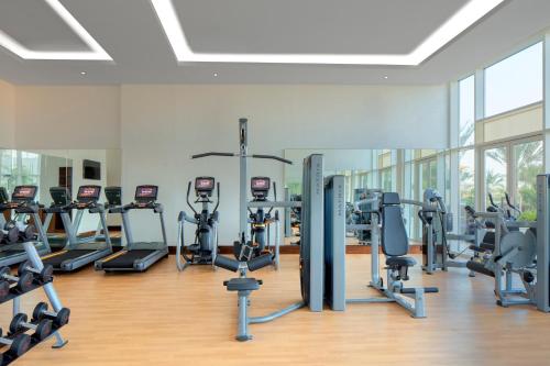 a gym with a lot of treadmills and exercise bikes at Crowne Plaza Muscat OCEC by IHG in Muscat