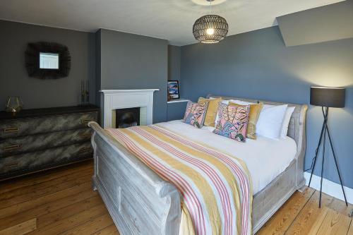 a bedroom with a bed with a blanket on it at Host & Stay - Arncliffe View in Egton