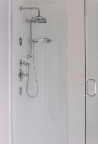 a shower in a bathroom with a glass door at The Inn at Hastings Park, Relais & Châteaux in Lexington