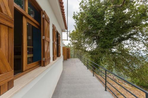 a balcony of a building with a tree on it at Casa do Caminheiro in Lousã
