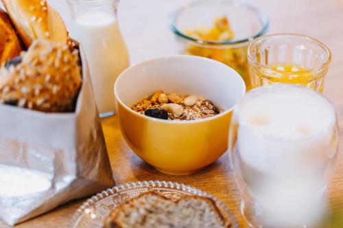 a table topped with a bowl of food and bread at Haus Braunarl in Lech am Arlberg
