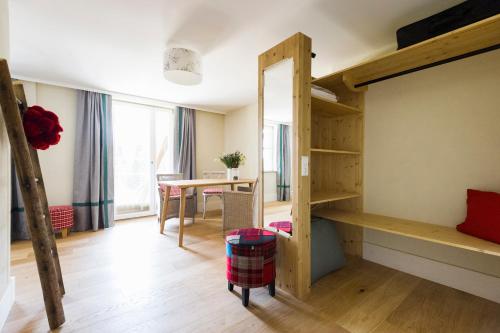 a room with a bunk bed and a table at Berghaus Freiburg - Appartement Hotel auf dem Schauinsland in Oberried
