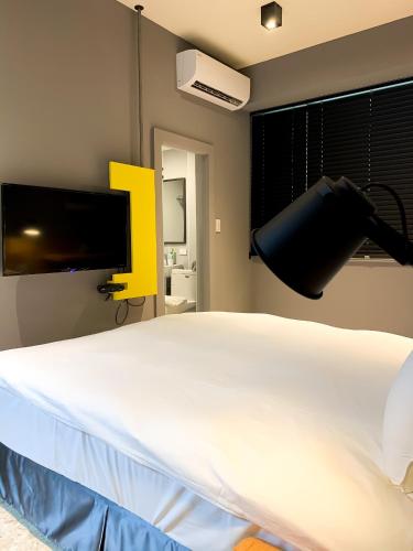 Postel nebo postele na pokoji v ubytování Raise Hotel Taichung