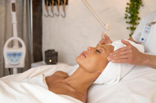 a woman laying in a hospital bed getting a massage at Treetop Spa Hangout & Hotel in Gothenburg
