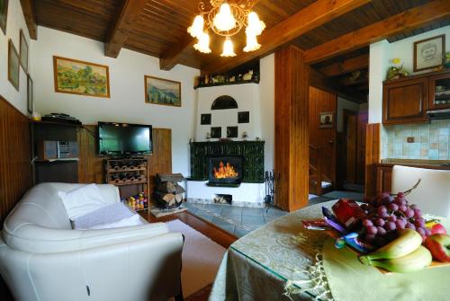 a living room with a table and a fireplace at Apartmánový dom Slniečko in Liptovský Ján