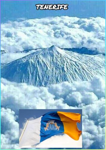 a flag flying in front of a snow covered mountain at Comfort in Adeje