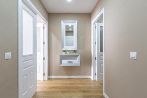 a bathroom with a sink and a mirror at Apartamento Sofia Ronda Center in Ronda