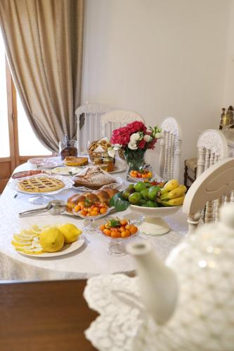 a table with plates of food and fruit on it at Agriturismo Cantina Morone in Guardia Sanframondi