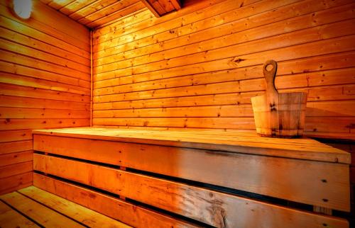 a wooden sauna with a wooden spoon on the wall at Horská chata Kouty in Loučná nad Desnou