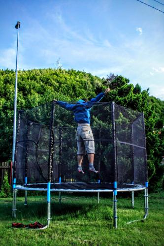 a man jumping on top of a trampoline at Horská chata Kouty in Loučná nad Desnou