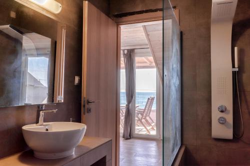 a bathroom with a sink and a view of the ocean at Isalos in Velika