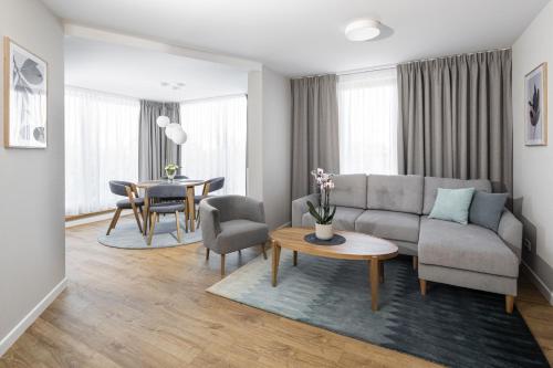 a living room with a couch and a table at Maloves Resort & Spa in Władysławowo