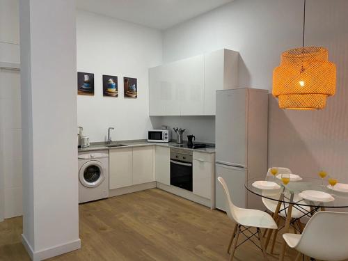 a kitchen with a table and a dining room at Aluche Aparment A in Madrid