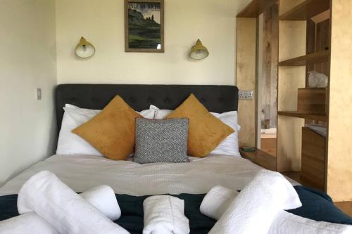 a bedroom with a large bed with pillows on it at The Hideaway in Orbost