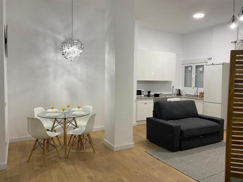 a living room with a table and a black couch at Aluche Aparment B in Madrid