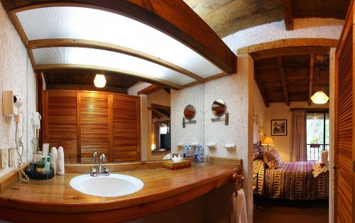 a bathroom with a sink and a large window at Hotel Villas Casa Morada in San Cristóbal de Las Casas