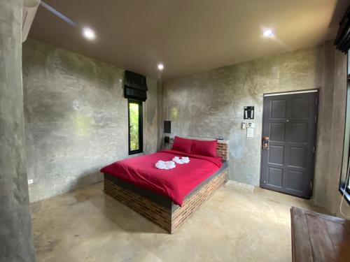 Watthana NakhonThe Loft House Sakaeo的一间卧室设有红色的床和黑色的门