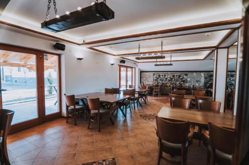 a dining room with wooden tables and chairs at Lazar Winery Tourism B&B in Rosoman