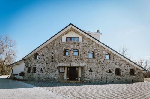 a large stone building with a large window at Lazar Winery Tourism B&B in Rosoman