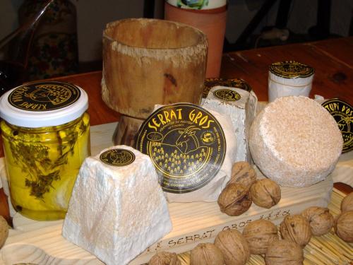 a table with bread and other food items on it at Casa Rural Molí de Fòrnols in Fornols