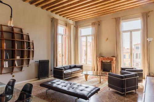 a living room with leather furniture and a fireplace at Cà Bellavista in Venice