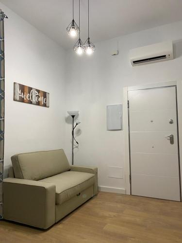 a living room with a couch and a door at Aluche Aparment C in Madrid