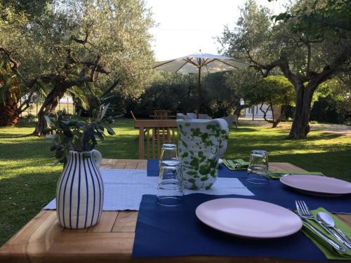 a table with plates and vases on top of it at Az. Agr. Parco dei Buoi in Larino