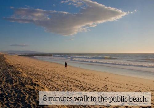 a person walking on a beach with the words minutes walk to the public beach at Mughal Suites in Ras al Khaimah
