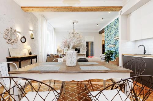 a kitchen and dining room with a table and chairs at Riga Old Town Jāņa Sēta Residence in Riga