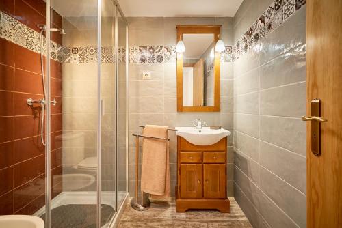 a bathroom with a sink and a glass shower at Casa Fonte da Mina in Fund�o