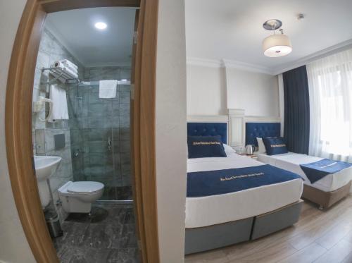 a bedroom with a bed and a shower and a toilet at Seher HOTEL in Istanbul