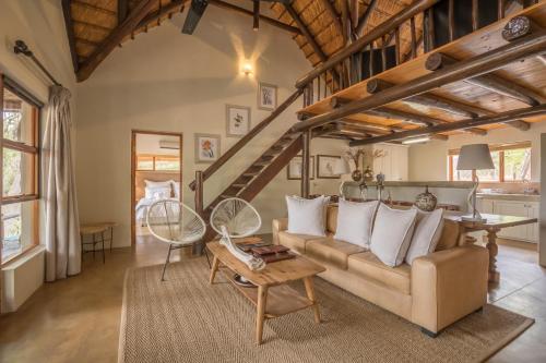a living room with a couch and a table at Karongwe - Kuname Safari Lodge in Hoedspruit