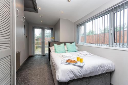 a room with a bed with a tray of food on it at James Cook Accommodation in Middlesbrough