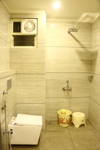 a bathroom with a toilet and a sink at lords residency in Bhopal