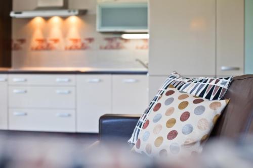 a pillow sitting on a chair in a kitchen at Aba Apartamenty in Krynica Zdrój