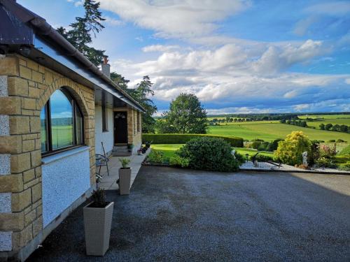a brick house with a view of the countryside at Hillhaven Bed &Breakfast in Fortrose