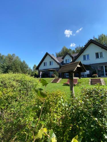 a group of houses in a field of grass at Lesny Apartament in Ostrzyce