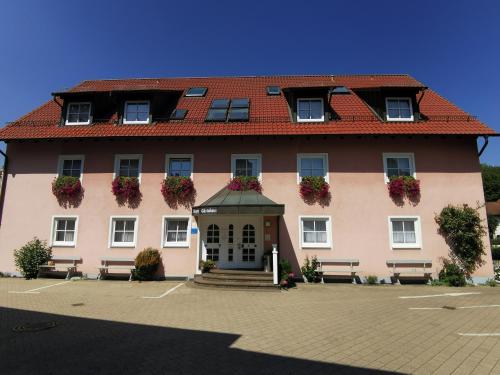a large pink building with a red roof at Gasthof Endres in Allersberg