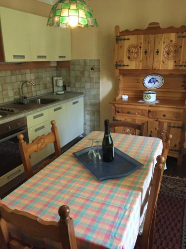 una cocina con una mesa con una botella de vino. en Camping & Resort Valle Romantica, en Cannobio