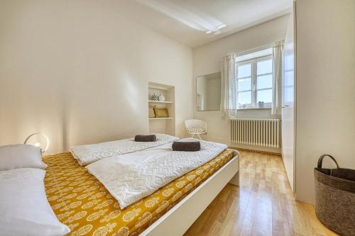 a bedroom with two beds and a window at APARTMENTS GASSER - Apartment 6 in Caldaro