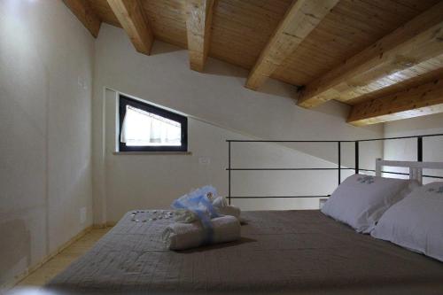 a bedroom with a large bed and a window at Casa Vacanza al Mare Villa Adriana in Granelli
